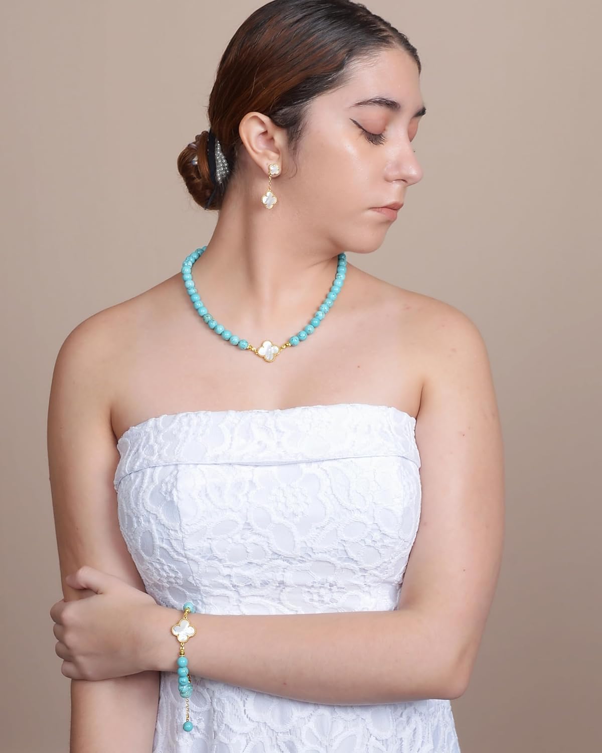 DIVA'S Turquoise 8mm Necklace with Mother Pearl Clover Detail on person wearing a white dress