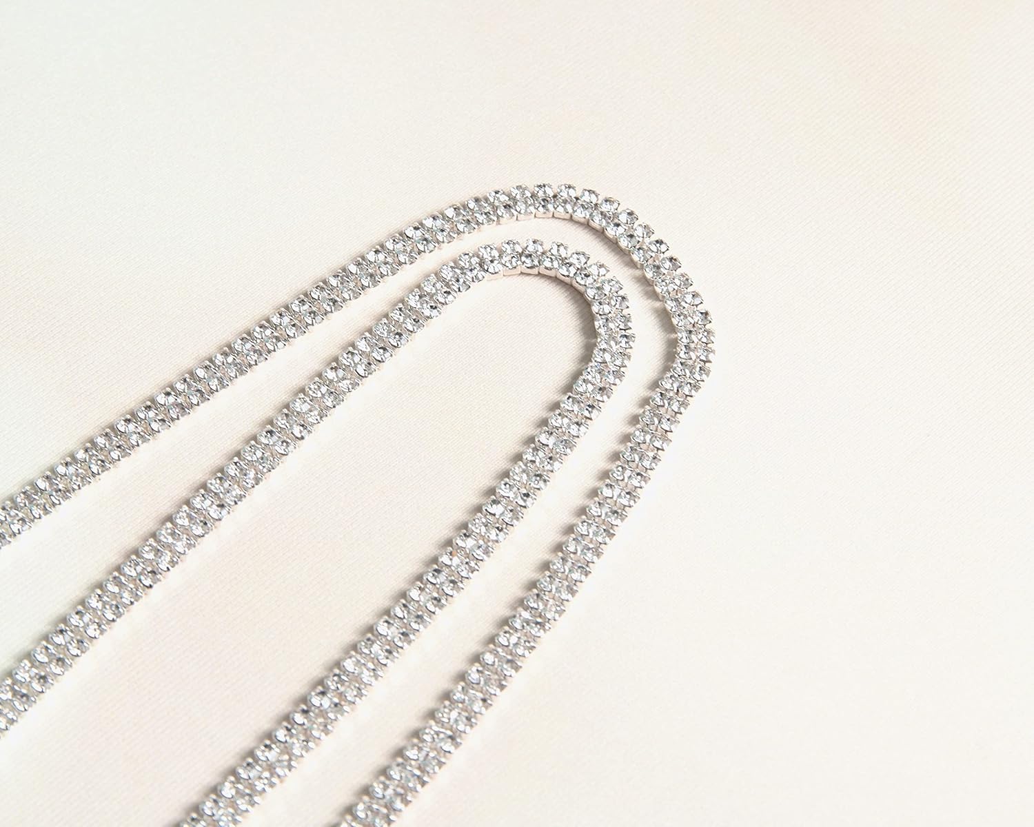 Rhinestone removable Gold - Silver Crystal Bra Straps, Multiple Sizes straps close up on plain beige background